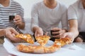 People eat fast food. Friends hands taking slices of pizza