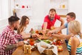 People eat pizza at festive table dinner party