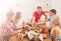 People eat pizza at festive table dinner party