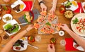 People eat pizza at festive table dinner party