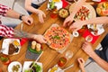 People eat pizza at festive table dinner party