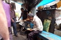 People eat in a small street restaurant in Kolkata