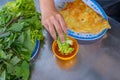 People eating Banh Xeo crepe with vegetable and dipping sauce