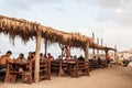 People eating on a beach restaurant