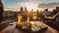People eating cheese and drinking wine at rooftop restaurant at sunset time. Restaurant table served with cheese plate, bread and Royalty Free Stock Photo