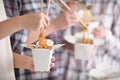 People eating chinese noodles from takeaway boxes, closeup Royalty Free Stock Photo