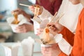 People eating chinese noodles from takeaway boxes, closeup Royalty Free Stock Photo