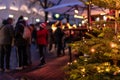 People eating and drinking at gastronomic stand at traditional famous christmas market