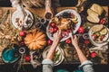 People eating festive dinner on Thanksgiving day with cat Royalty Free Stock Photo