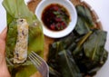 People eating flat rice dumpling on tray food background, special cake of Hue, delicious vegan rice flour dish Royalty Free Stock Photo