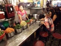 People eating in front of the cook in a restaurant in an alley of Namdaemun market. Seoul