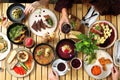People eating a lunch together, top view. Enjoying dinner, sharing dishes with friends. Vegan friendly restaurant. Royalty Free Stock Photo