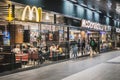 People eating at McDonalds / McCafe restaurant inside train stration Berlin Hauptbahnhof