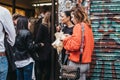 People eating and queuing to buy bagels from a famous Beigel Shop in Brick Lane, London, UK Royalty Free Stock Photo