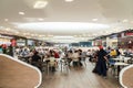 People Eating At Restaurant In Luxury Shopping Mall Interior