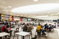 People Eating At Restaurant In Luxury Shopping Mall Interior