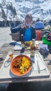 People eating on a ski restaurant over Engelberg on the Swiss alps