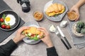 People eating tasty croissant sandwiche