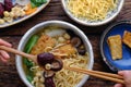 People eating Vietnamese vegan noodle soup for breakfast