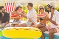 People eating watermelon by the pool Royalty Free Stock Photo