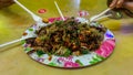 People eating Yong Tau Foo or Yentafu, a Chinese cuisine using plastic fork on a table Royalty Free Stock Photo