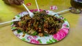 People eating Yong Tau Foo or Yentafu, a Chinese cuisine using plastic fork on a table Royalty Free Stock Photo