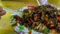 People eating Yong Tau Foo or Yentafu, a Chinese cuisine using plastic fork on a table Royalty Free Stock Photo