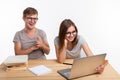 People and education concept - Two laughing students sitting at a table Royalty Free Stock Photo