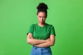 Portrait of offended black woman standing with folded arms