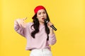 People emotions, lifestyle leisure and beauty concept. Stylish and cool young girl rapper in red cap, singing song and Royalty Free Stock Photo