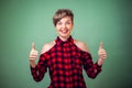 People and emotions - a portrait of smiling woman with short dark hair showing thumbs up Royalty Free Stock Photo