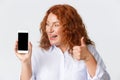 People, emotions and technology concept. Close-up of amazed and excited, smiling middle-aged woman with red hair