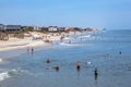 people enjoy bathing in Nags Head, USA. Established in the 1830s as first tourist colony. The first oceanfront cottage was built