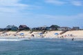 people enjoy bathing in Nags Head, USA. Established in the 1830s as first tourist colony. The first oceanfront cottage was built