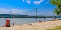 People enjoy on a beach Strand on a Danube river, view at Liberty Bridge Most Slobode in Novi