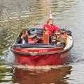 People enjoy a boat tour in canal, Amsterdam, Netherlands Royalty Free Stock Photo