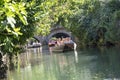 people enjoy a boat trip on a green canal in Colmar
