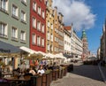People enjoy drinks and food in one of the many street cafes and restaurants in the hsitoric old town of Danzing on a beautiful