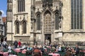 People enjoy food and drink on sidewalk cafe