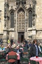 People enjoy food and drink on sidewalk cafe