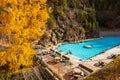 People enjoy hot springs in outdoor pool in autumn