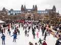 People enjoy ice skating in front of Rijksmuseum