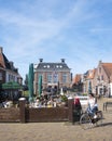 People enjoy nice weather on open air cafe in village of makkum in the netherlands