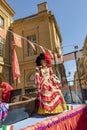 people enjoy the performance at the The Mirabelle Plum Festival in Metz, France. people in venetian costumes perform a parade