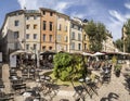 People enjoy the restaurant at the central market place with fou