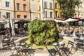 People enjoy the restaurant at the central market place with fou