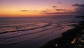 People enjoy the romantic sunset at the popular Echo Beach in Canggu on the tropical island of Bali. Tourist sitting and Royalty Free Stock Photo