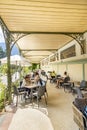 people enjoy sitting in Wandelhalle building with bench in Merano, South Tyrol. The Wandelhalle was originally erected in the