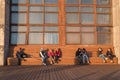 People enjoy sunlights sitting on bench in Sevkabel in Saint Petersburg, Russia