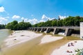 People enjoy sunny hot weather on the river banks of Isar river in Munich.